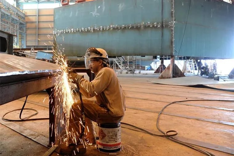 At Aker Philadelphia Shipyard, Lewis Pierce, 55, of Williamstown, grinds a plate for the hull of a ship under construction. The company has also restarted an apprenticeship program that was suspended in July 2010.