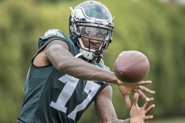Eagles wide reciever Alshon Jeffery concentrates as the ball comes to him during a passing drill after practice on Thursday. Eagles practice with a full squad on Thursday, the first day of training camp for the entire team.