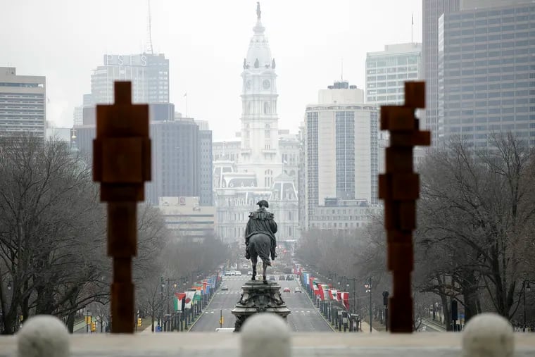 City Hall is seen amongst a group of Cast-iron sculptures by British artist Antony Gormley, titled STAND at the steps of the Philadelphia Museum of art in Philadelphia, Thursday, Feb. 7, 2019. (AP Photo/Matt Rourke)
