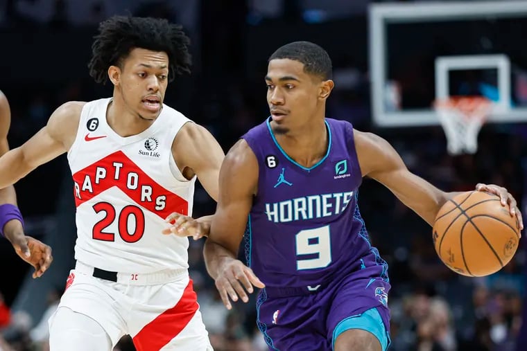 Charlotte Hornets guard Theo Maledon (9) drives past Toronto Raptors guard Jeff Dowtin Jr. during the first half of an NBA basketball game in Charlotte, N.C., Sunday, April 2, 2023. (AP Photo/Nell Redmond)