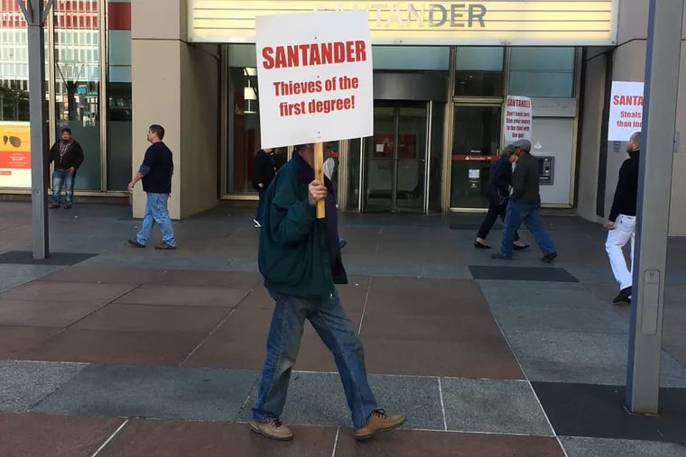 Attorney Chuck Peruto Jr.’s volunteers picket the Santander Bank branch at 1500 Market Street last week.