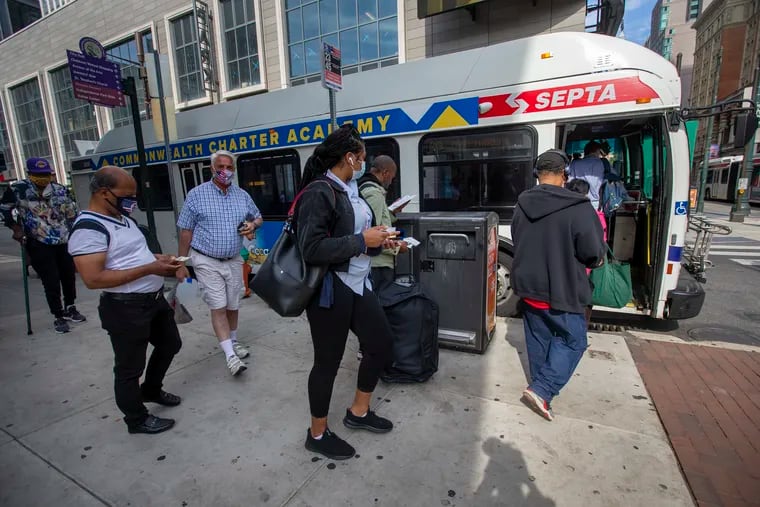 SEPTA bus riders gather to enter bus at 11th and Market Streets in June.