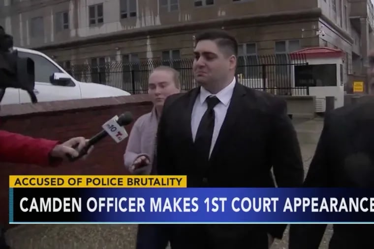 In this file photo, Camden County police officer Nicholas Romantino (center), 26, of Egg Harbor, leaves the federal courthouse in Camden in November after he was released on a $50,00 bond after a grand jury charged him with punching an unarmed suspect in the head.