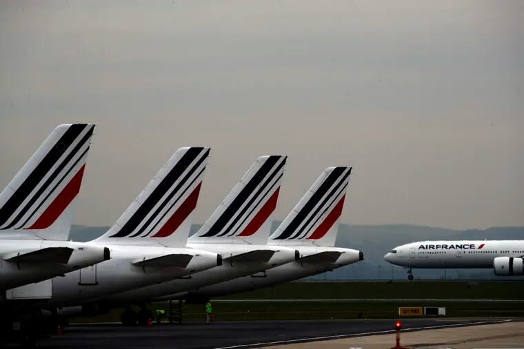 FILE - In this May 17, 2019 file photo, Air France planes are parked on the tarmac at Paris Charles de Gaulle airport, in Roissy, near Paris. The French government will implement an "ecotax" on plane tickets for flights departing from France from next year, the government said Tuesday July 9, 2019. The tax is expected to raise over 180 million euros ($200 million) from 2020 to invest in eco-friendly transport infrastructure, including rail.