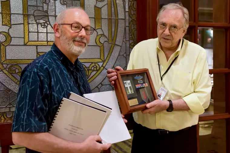 Amateur military historian Ed Mikus (left) developed a complete biography about a soldier killed on D-Day who was mentioned in a column by columnist Stu Bykofsky (right). In addition to the biography, Mikus created a display case with honors the soldier earned. Mikus presented the case to Bykofsky on July 1, 2019.