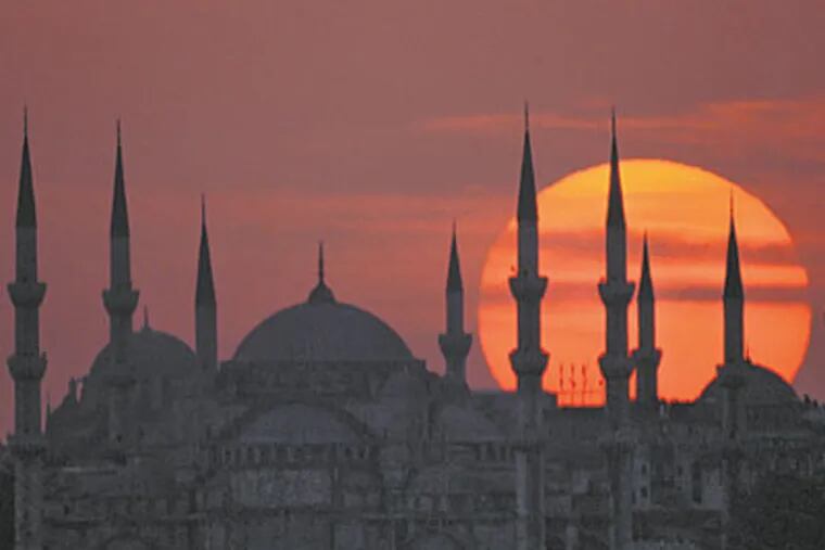 The sun sets behind Istanbul's Blue Mosque, with its vast dome and six minarets. It’s still used as a mosque, and is a popular tourist attraction.