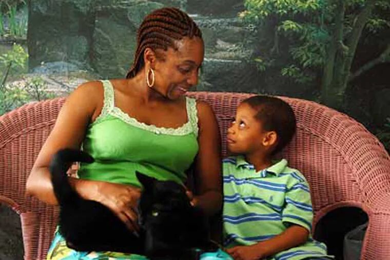 Shelly Long, in her Northeast Philadelphia home with her four-year-old son, Sincere Brower, is hoping she lands a job as a Philadelphia corrections officer. She recently applied at a Philadelphia Prison System "Open House." (Sharon Gekoski-Kimmel/Inquirer)