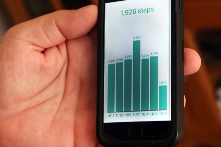 Knee-replacement patient Michael Greco has an app on his phone that measures his steps.