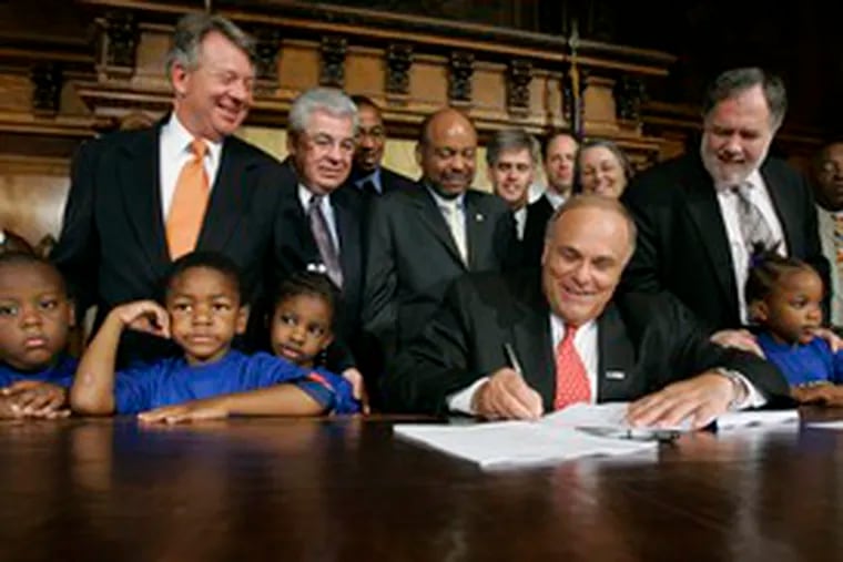 More than two weeks into the fiscal year, Gov. Rendell signs the 2007-08 state budget. Surrounding him yesterday were children from the Harrisburg School District, as well as lawmakers and officials.