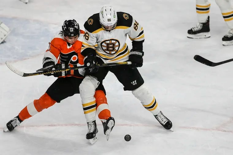 The Flyers' Travis Konecny (left) batles Boston's Kevan Miller during the third period at the Wells Fargo Center on Tuesday. The teams meet again Saturday afternoon.