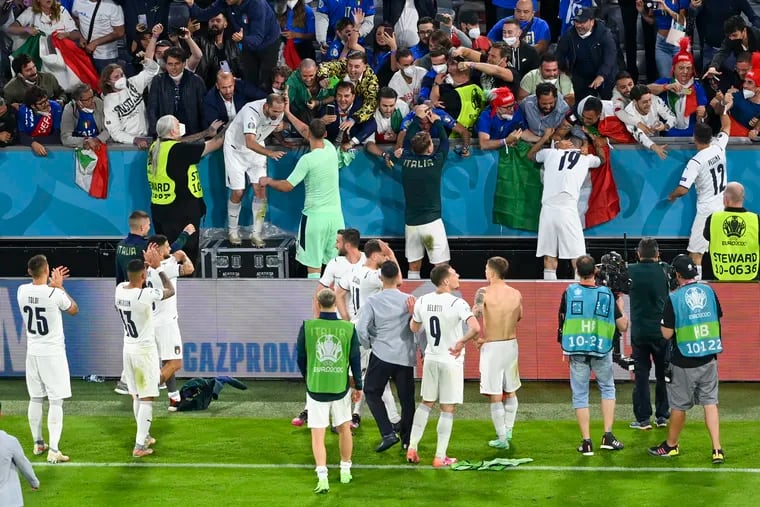 Italy players celebrate with fans in the stands after ousting Belgium in the European Champioonship quarterfinals on Friday.