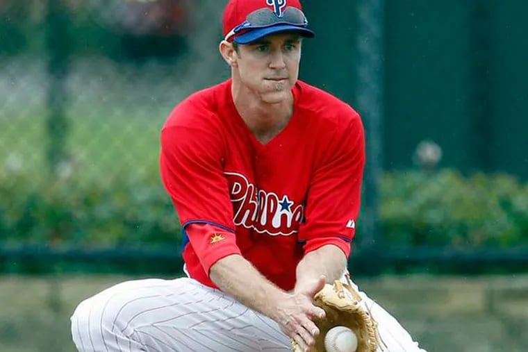 Chase Utley fields the baseball during spring training in Clearwater, FL on Thursday, February 14, 2013. (Yong Kim/Staff Photographer)