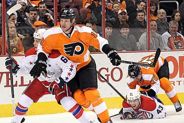 The Flyers' Adam Hall blocks out the Capitals' Steve Oleksy as the Flyers' Chris VandeVelde takes down the Capitals' Tom Wilson. (Yong Kim/Staff Photographer)