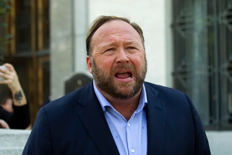 FILE--In this Sept. 5, 2018, file photo, Alex Jones speaks to reporters in Washington. Lawyers in Connecticut, on Monday, June 17, 2019, allege conspiracy theorist Alex Jones sent them electronic files containing child pornography as part of a defamation lawsuit against the Infowars host by relatives of some victims of the Sandy Hook Elementary School shooting. The families of eight victims of the 2012 shooting in Newtown, Conn. and an FBI agent who responded to the massacre are suing Jones, Infowars, and others for promoting a theory that the shooting was a hoax.
