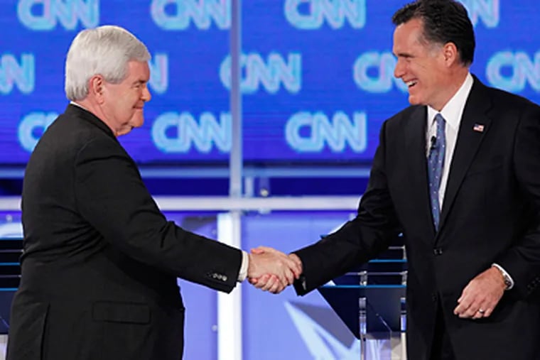 Republican front-runners Newt Gingrich (left) and Mitt Romney shake hands at the start of Thursday night's debate in Florida. (Matt Rourke / Associated Press)