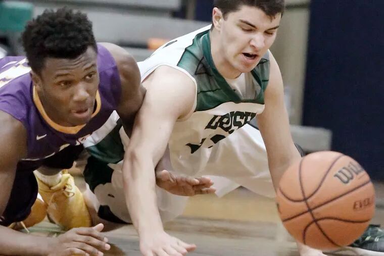 Camden Catholic's Dominic Dunn (right), diving for a loose ball with Camden's Ethan Tarte, is one reason the Irish have promise for next season.