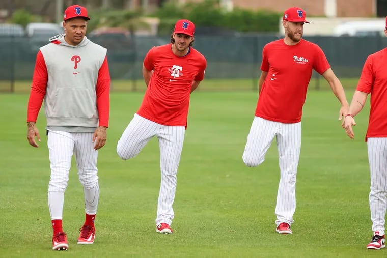 Taijuan Walker (left) will open the season on the injured list. When will he be ready to join Aaron Nola (center) and Zack Wheeler (right) in the Phillies' starting rotation?