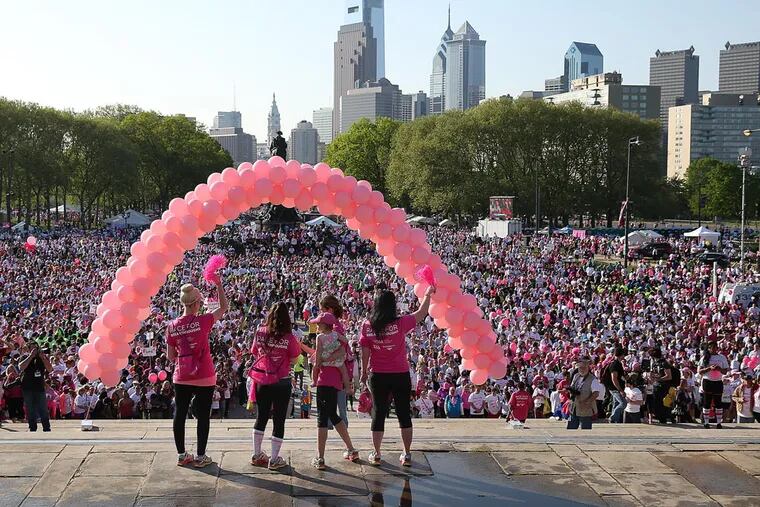 Race cochairs and cancer survivors (left to right) Rachel Toomey, Jackie Roth, Maureen Manfrey, her daughter, Josephine, and Jeannine Donnahue wave from the steps of the Philadelphia Museum of Art during the 24th annual Susan G. Komen Philadelphia Race for the Cure in Philadelphia on May 11, 2014. 
( DAVID MAIALETTI / Staff Photographer )