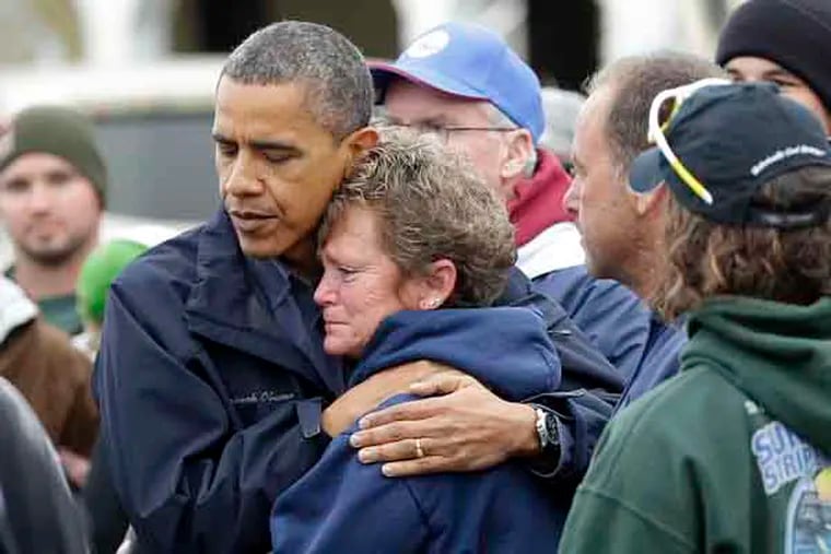 President Barack Obama, left, embraces Donna Vanzant, right, during a tour of a neighborhood effected by superstorm Sandy, Wednesday, Oct. 31, 2012 in Brigantine, N.J. Vanzant is a owner of North Point Marina, which was damaged by the storm. (AP Photo/Pablo Martinez Monsivais)