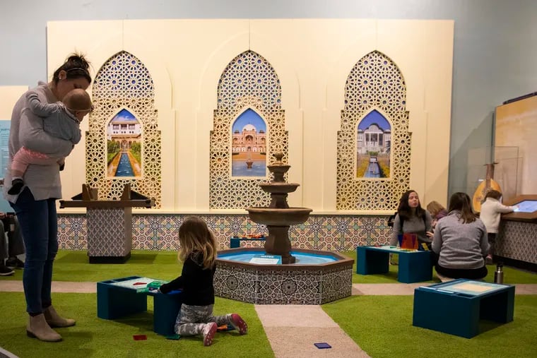 Parents and their children play in the courtyard of the newest exhibit at the Please Touch Museum, "America to Zanzibar: Muslim Cultures Near and Far" on Thursday, Jan. 31, 2019. The exhibit is a first in the museum's history to explore a religious culture, and will be open for six months.