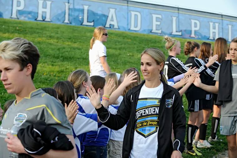 Philadelphia Independence defender Heather Mitts greets youth soccer players in April 2010.