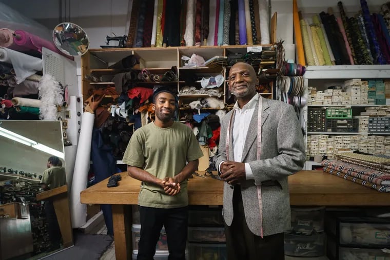 Chris Baldwin, left, and his father Larnell Baldwin, right, owner of Baldwin Fine Custom Tailoring, which is a black-owned business and has been in the same Queen Village location for 40 years.