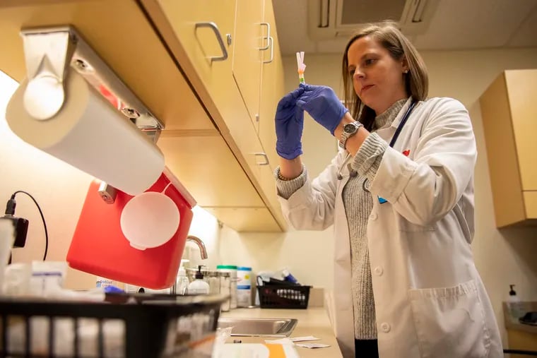 Kelly Moran, a nurse practioner, prepares a flu vaccine at a CVS MinuteClinic in Philadelphia.