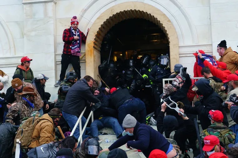 Rioters clash with police as they try to gain entrance to the U.S. Capitol during the Jan. 6, 2021, insurrection.