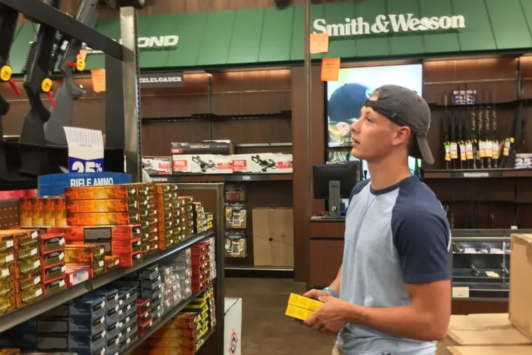 Tyler James, 18, shops for ammunition for his hunting rifle, saying &quot;everything's so cheap&quot; with Gander Outdoors’ going-out-of-business sales.
