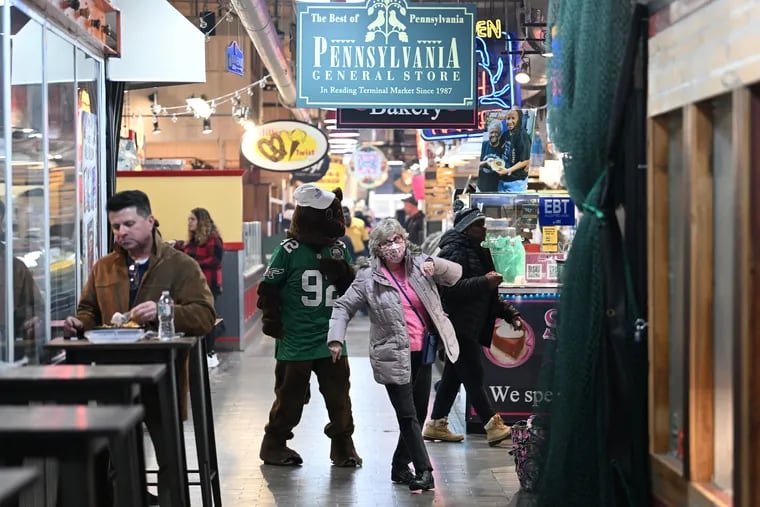 Kitty Weidner, 68, dances with the Punxsutawney Phil outside of the Pennsylvania General Store at Reading Terminal Market.