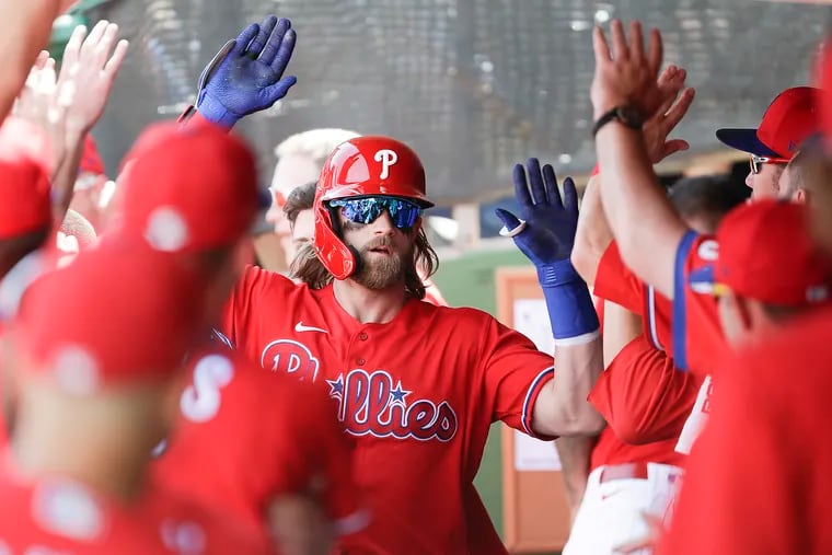 Bryce Harper gets high-fives after his two-run home run in the first inning against Pittsburgh.