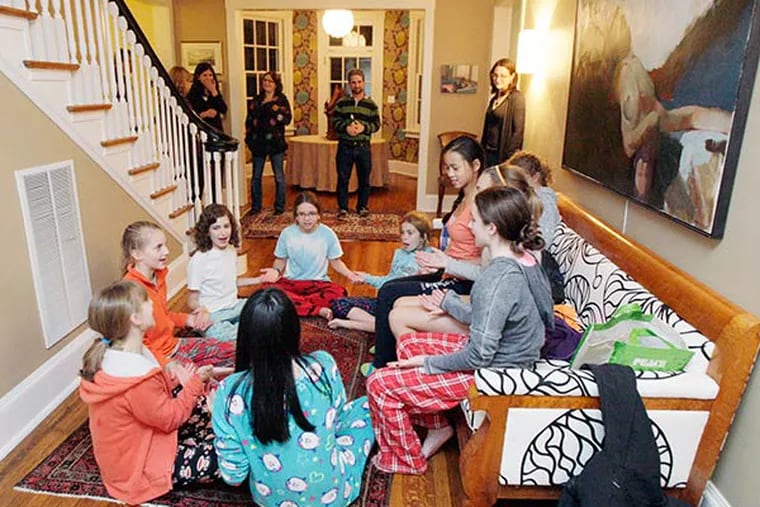 Parents arrive to pick up their girls and wait as they play a game during the sleepunder at the Gorman's home in Elkins Park on October 25, 2013.  ( ELIZABETH ROBERTSON / Staff Photographer )
