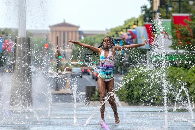 Amina Jones, 11, of Philadelphia, beats the heat at the reopened Love Park fountain on a steamy Monday.