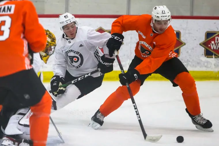 Right wing Bobby Brink (left, no. 46) battles for the puck against left wing Noah Cates (right, no. 71) at the Philadelphia Flyers Development Camp at the Flyers Skate Zone in Voorhees, NJ on Friday, June 28, 2019.