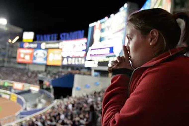 From right field, Sarah Smedley of Hadonfield watches the Phils bat in the fourth inning during Game 2 of the World Series.  ( Elizabeth Robertson / Staff Photographer )