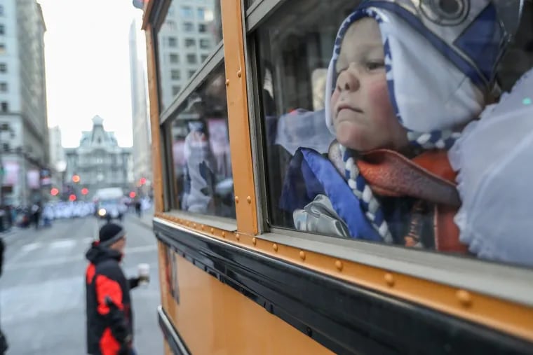 Cole Lubinsky, 6, presses his face against the school bus window as he and the other small children dressed as wenches for American NYB Comic presentation of The Empire Struts Back at the Mummers Parade.