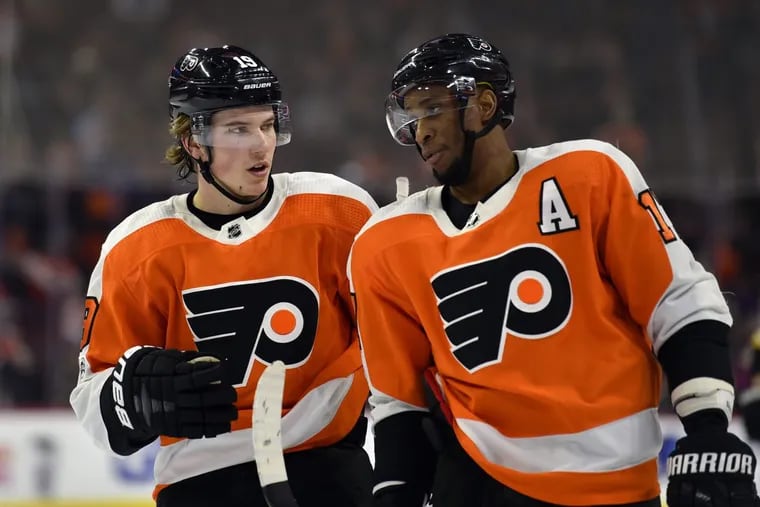 Flyers’ rookie Nolan Patrick, left, talks to Wayne Simmonds during the Flyers’ 5-2 win over the Flames.