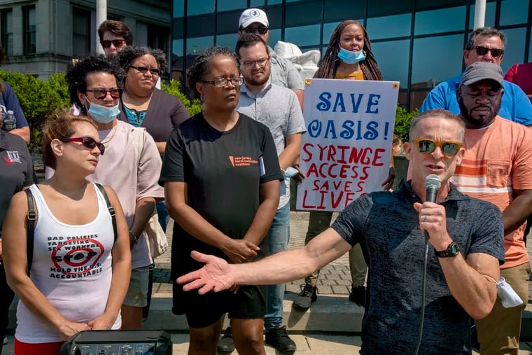 Jay Lassiter (front, right) speaks at a protest against the closing of the Oasis Drop in Center in Atlantic City last week. City Council seems likely to close it down. It is the only needle exchange site in the city and one of only seven in New Jersey.