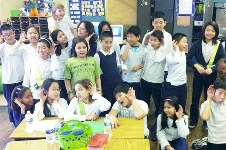 Fifth-grader teacher Joanna Bottaro (hiding in the back) and her students at the Gen. George McCall School are studying the art of listening and how it helps others feel emotionally connected and cared for.