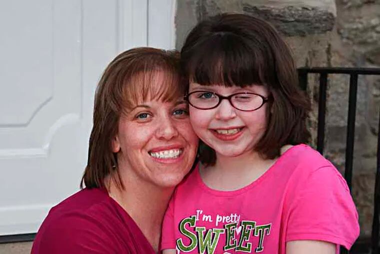 Sandra Stewart and her daughter Corin Stewart, 9, a cancer survivor who is selling Alex's Lemonade this Saturday as a thank you to org. that gave $$$ to fly her & mom to Florida for proton radiation treatments. At her NE Philadelphia home Wednesday, April 24, 2013. (  Steven M. Falk / Staff Photographer )