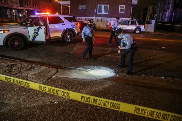 Two men, 20 and 22, were shot at Front Street and Champlost Avenue in the Olney section of Philadelphia shortly after 10 p.m. Friday. Police look for some of the 40 rounds fired at the scene.