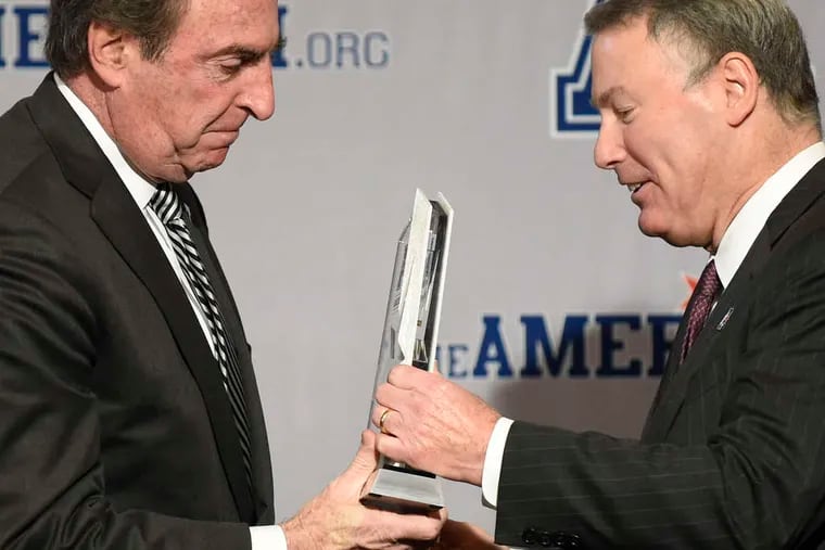 Temple coach Fran Dunphy (left) accepts his award from AAC commissioner Mike Aresco. Dunphy paid tribute to a fallen friend in accepting the honor.