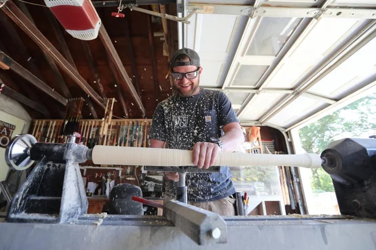 Steve McCardell, of Prowler Bats, forms a bat from a block of ash on his lathe in his West Chester garage.