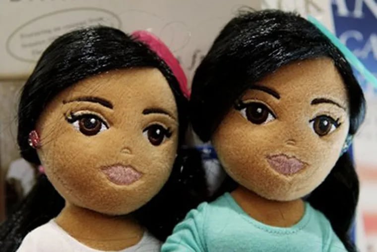 The Sweet Sasha, left, and Marvelous Malia dolls, made by Ty Inc., at Lamont's gift shop at the Ritz-Carlton Hotel in Chicago. The daughters of President Barack Obama are the inspiration for the latest in the TyGirlz Collection. (AP Photo/Charles Rex Arbogast).