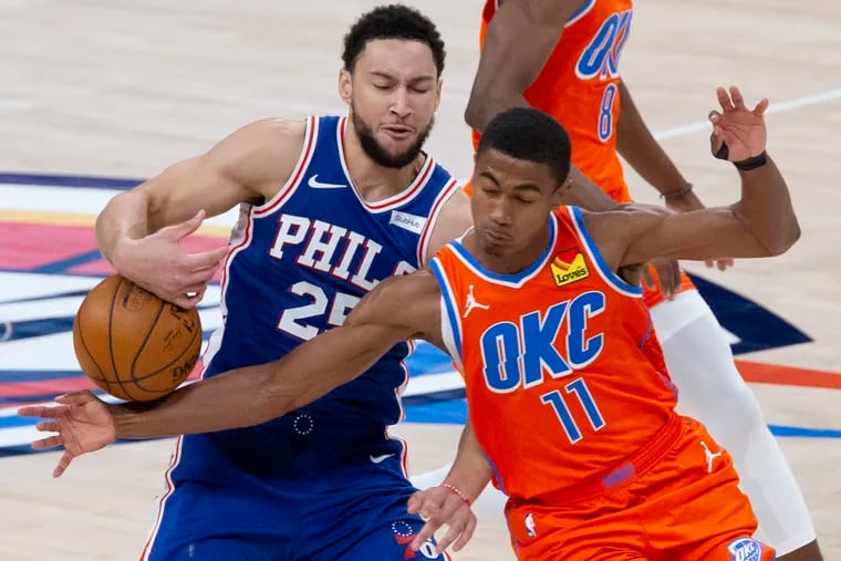Oklahoma City Thunder guard Theo Maledon (11) tries to steal the ball from Philadelphia 76ers guard Ben Simmons (25) during the second half of an NBA basketball game on Saturday.