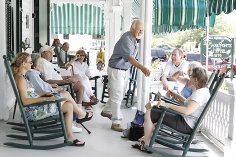 Bob Mullock greets guests enjoying the Chalfonte's wraparound porch. He and his wife, Linda, bought the hotel in 2008. (Elizabeth Robertson / Staff Photographer)