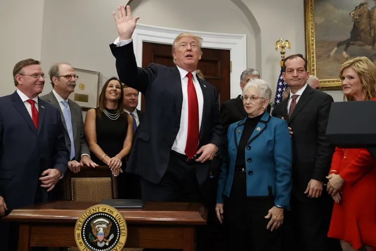 President Trump waves after signing an executive order on health care in the Roosevelt Room of the White House, Thursday, Oct. 12, 2017. (AP Photo/Evan Vucci)