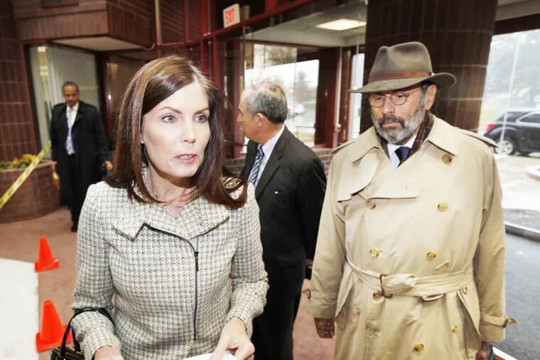 Pennsylvania Attorney General Kathleen Kane a reads a statement to reporters Monday, Nov. 17, 2014 upon her arrival in Norristown, Pa., to testify before a grand jury. Kane indicated Monday that the investigation deals with an alleged violation of grand jury secrecy by her office.  Attorney Gerald Shargel is at right. (AP Photo/The Philadelphia Inquirer, Michael Wirtz)  PHIX OUT; TV OUT; MAGS OUT; NEWARK OUT