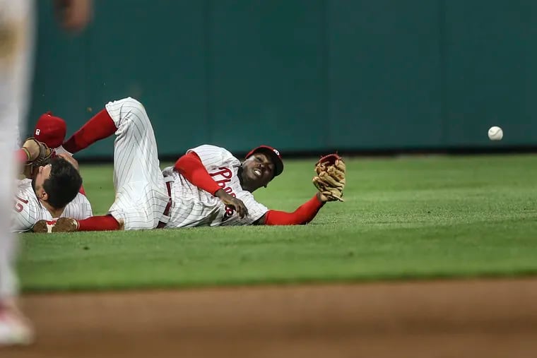 Phillies left fielder Kyle Schwarber, left collides with shortstop Didi Gregorius on a Rangers Mitch Garver hit  during the 7th inning at Citizens Bank Park on Wednesday.