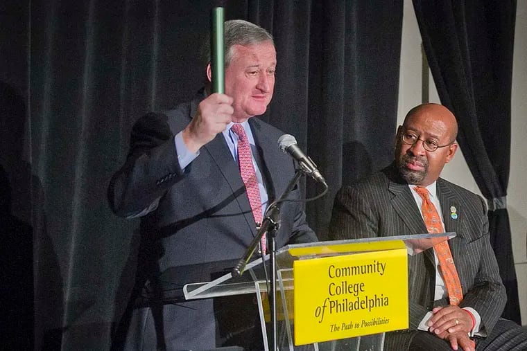 Mayor-elect Jim Kenney (left) holds a baton he received from Mayor Nutter at the annual summit for My Brother’s Keeper, intended as a sign of continued support of the group.